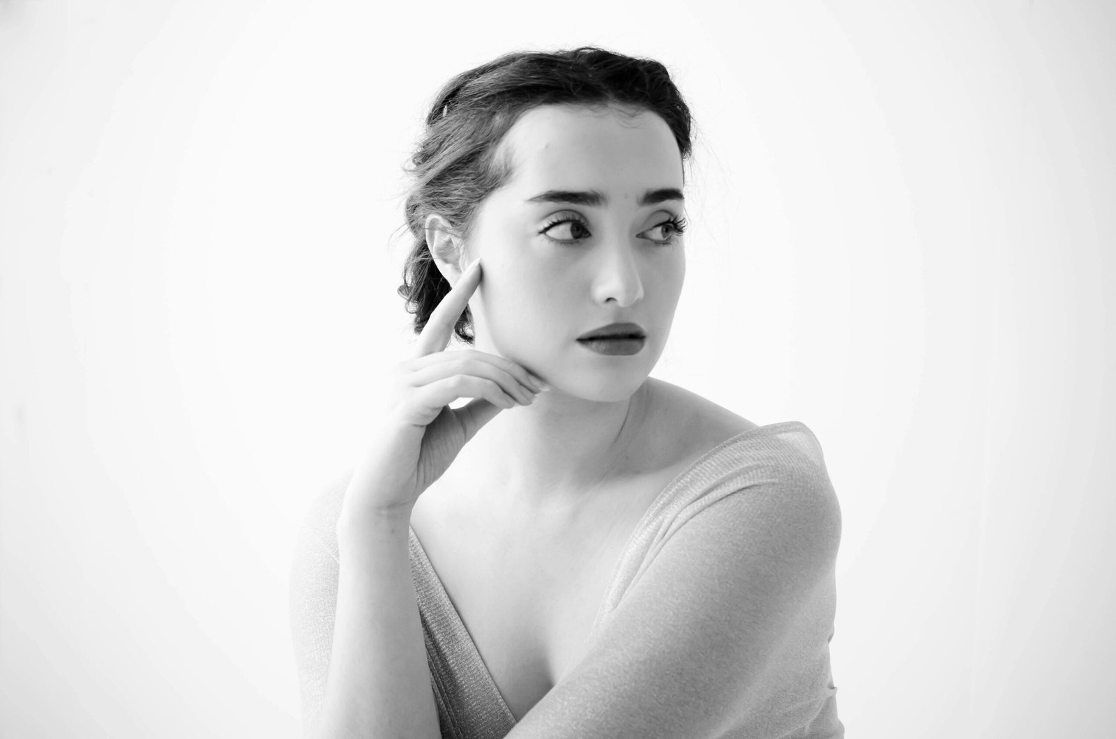 A stunning black and white portrait of a woman in a contemplative pose, captured in Pretoria.